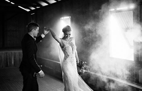 bride and groom dancing in old barn
