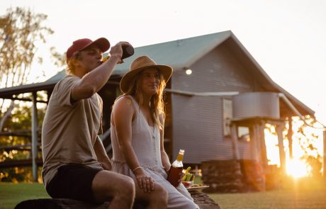 couple having a sunset drink outside of cabin at hedlow retreat