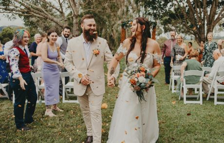 Bride and Groom walking back down the aisle with petals